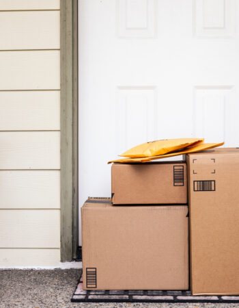 Front Door of House with Stack of Delivery Boxes from Online Ordering and E-commerce